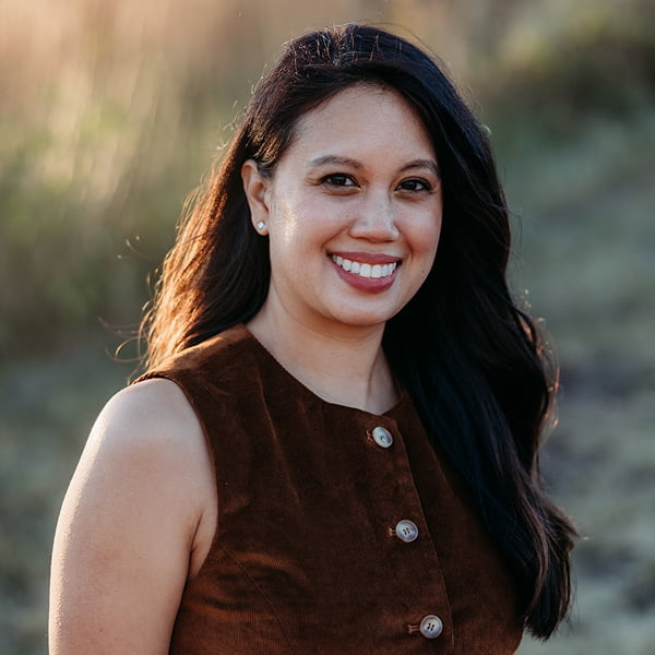 Dr. Kristine Streitz in a brown dress standing confidently